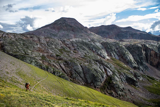 a person hiking up a mountain