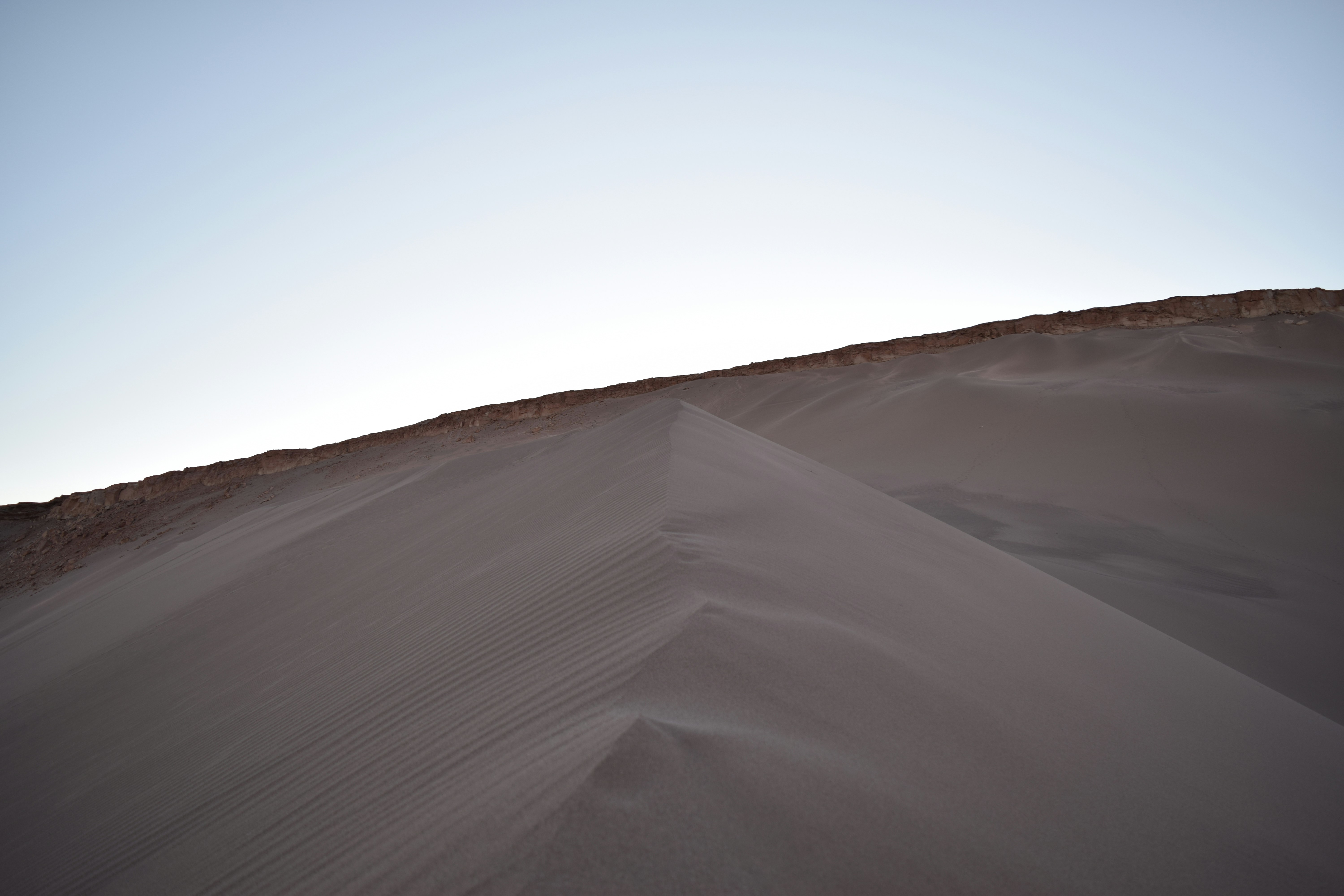 a sandy beach with a blue sky, 