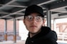 a man wearing glasses and a hat