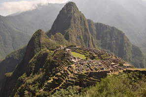 The ancient ruins of Machu Picchu perched high in the misty Andes mountains.