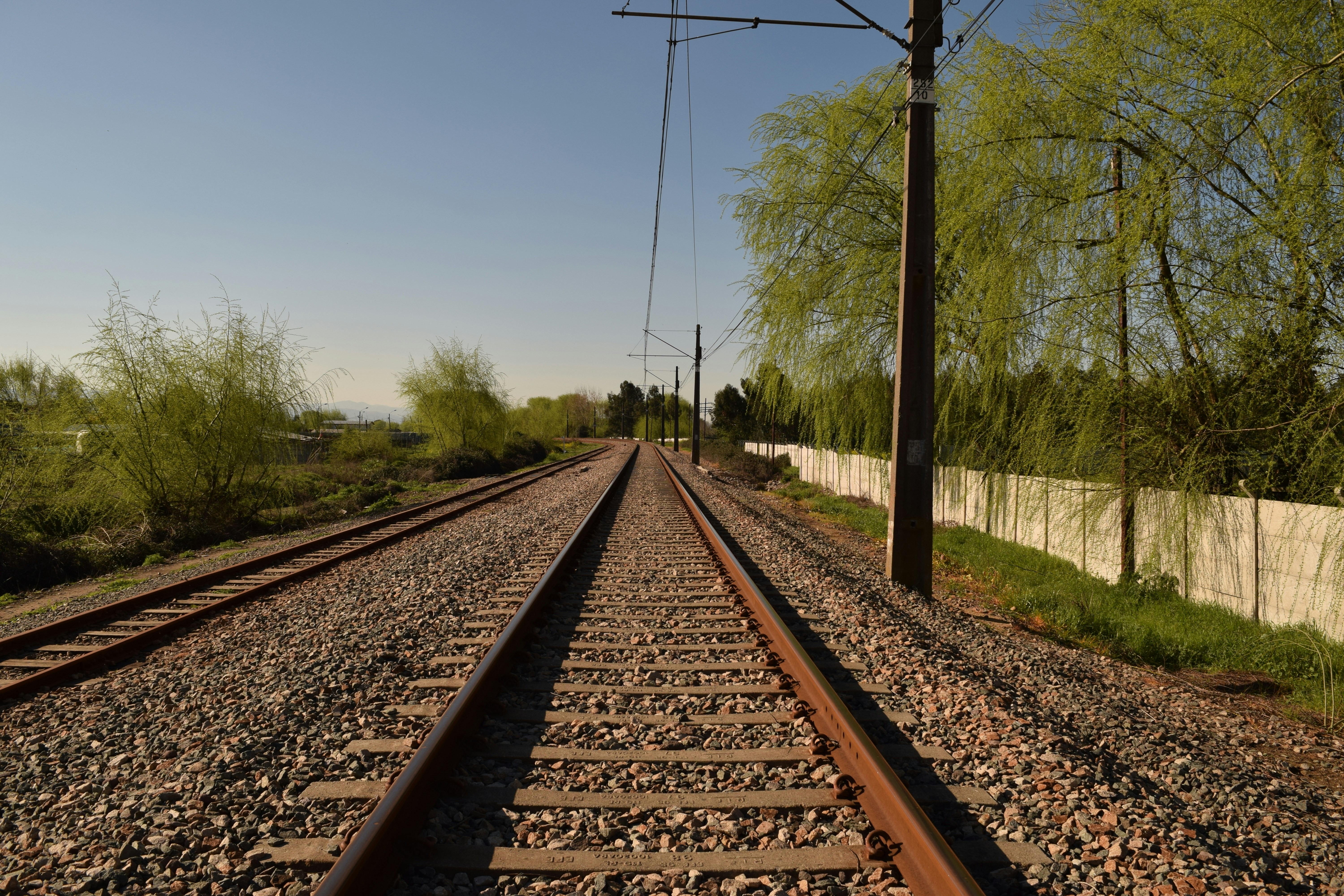 a railroad track with trees on either side of it