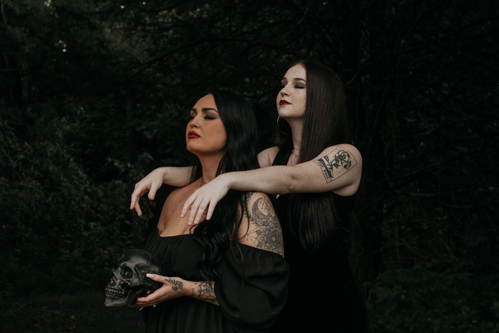 two women in black dresses