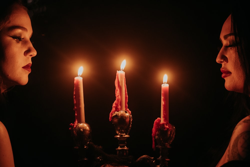 a woman and a man holding candles