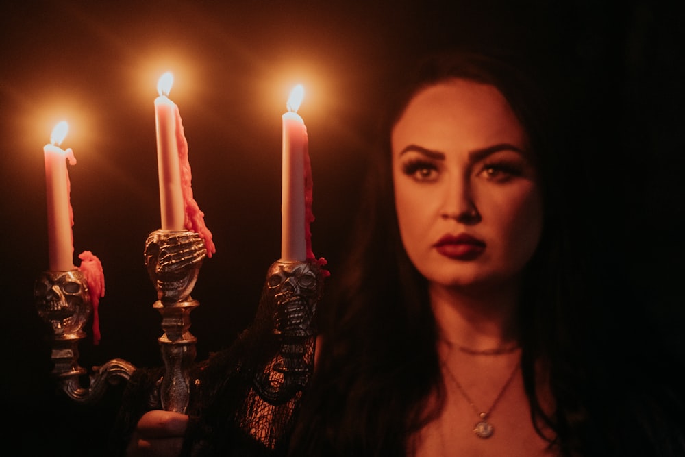 a woman holding candles
