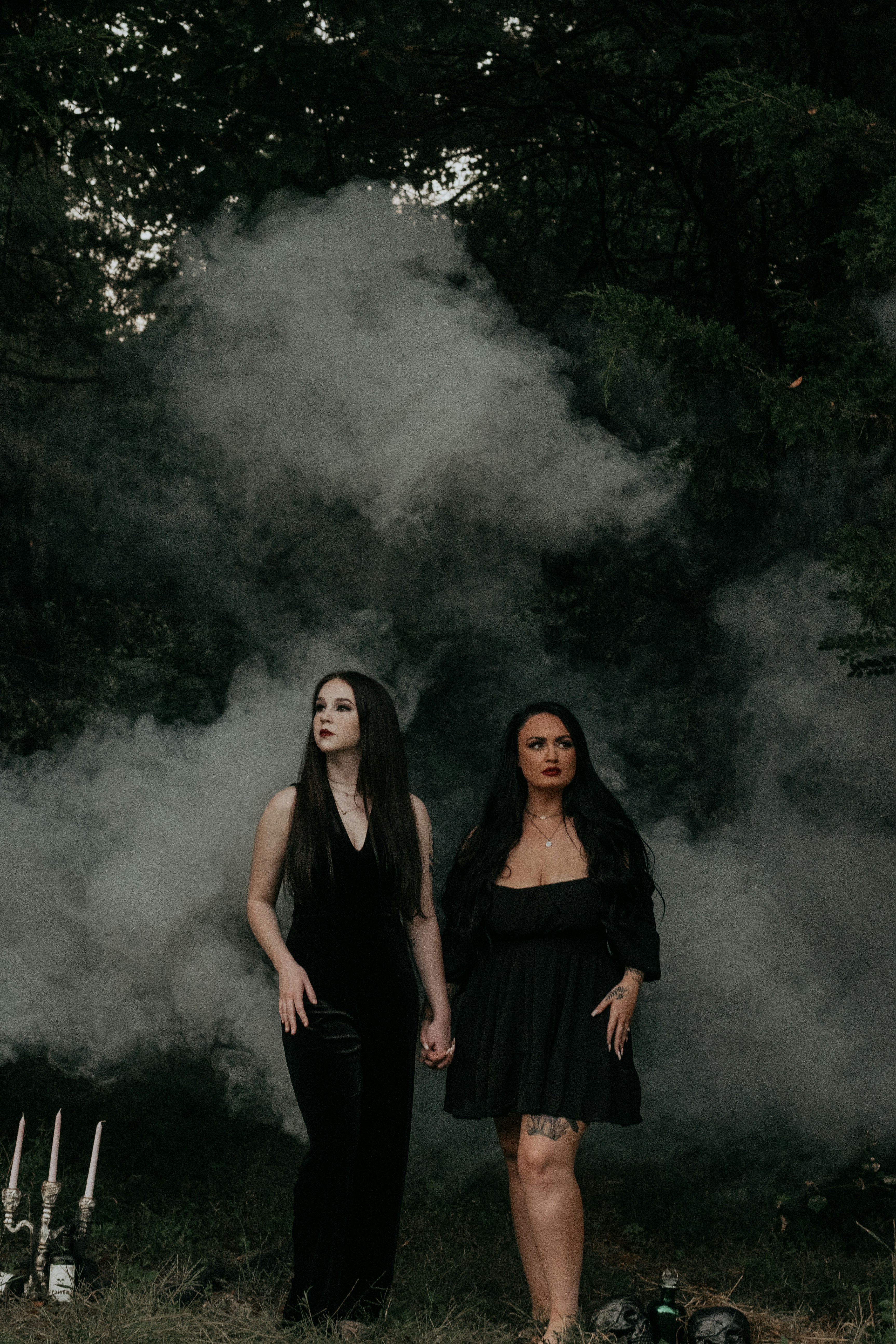 two women standing in front of a large mushroom cloud
