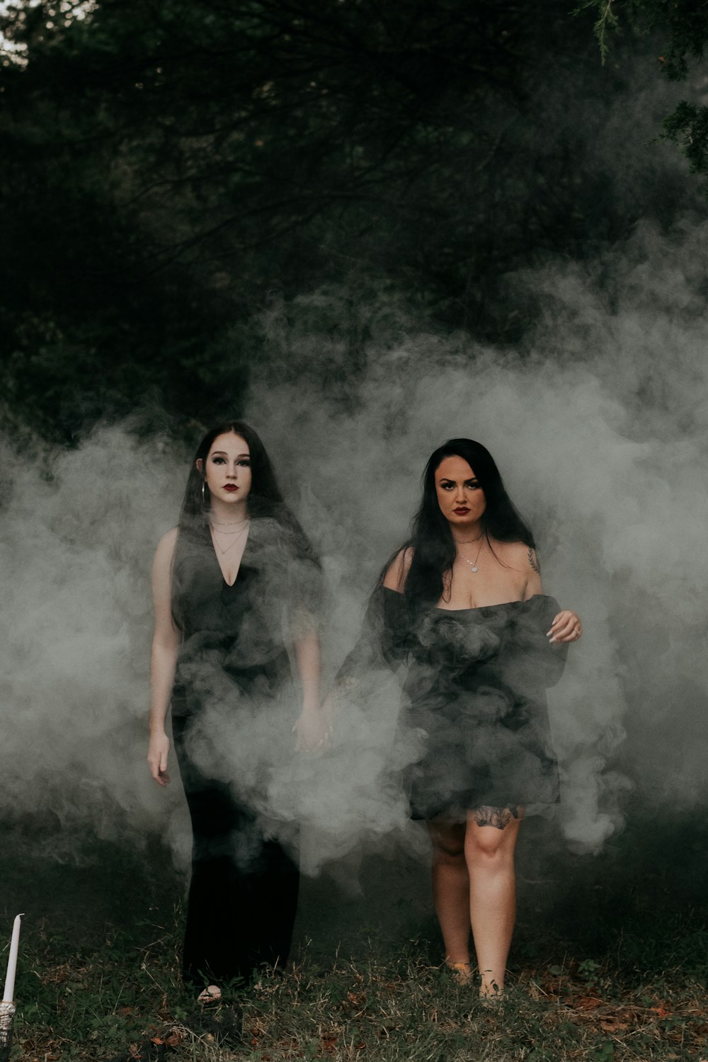 two women standing in front of a waterfall