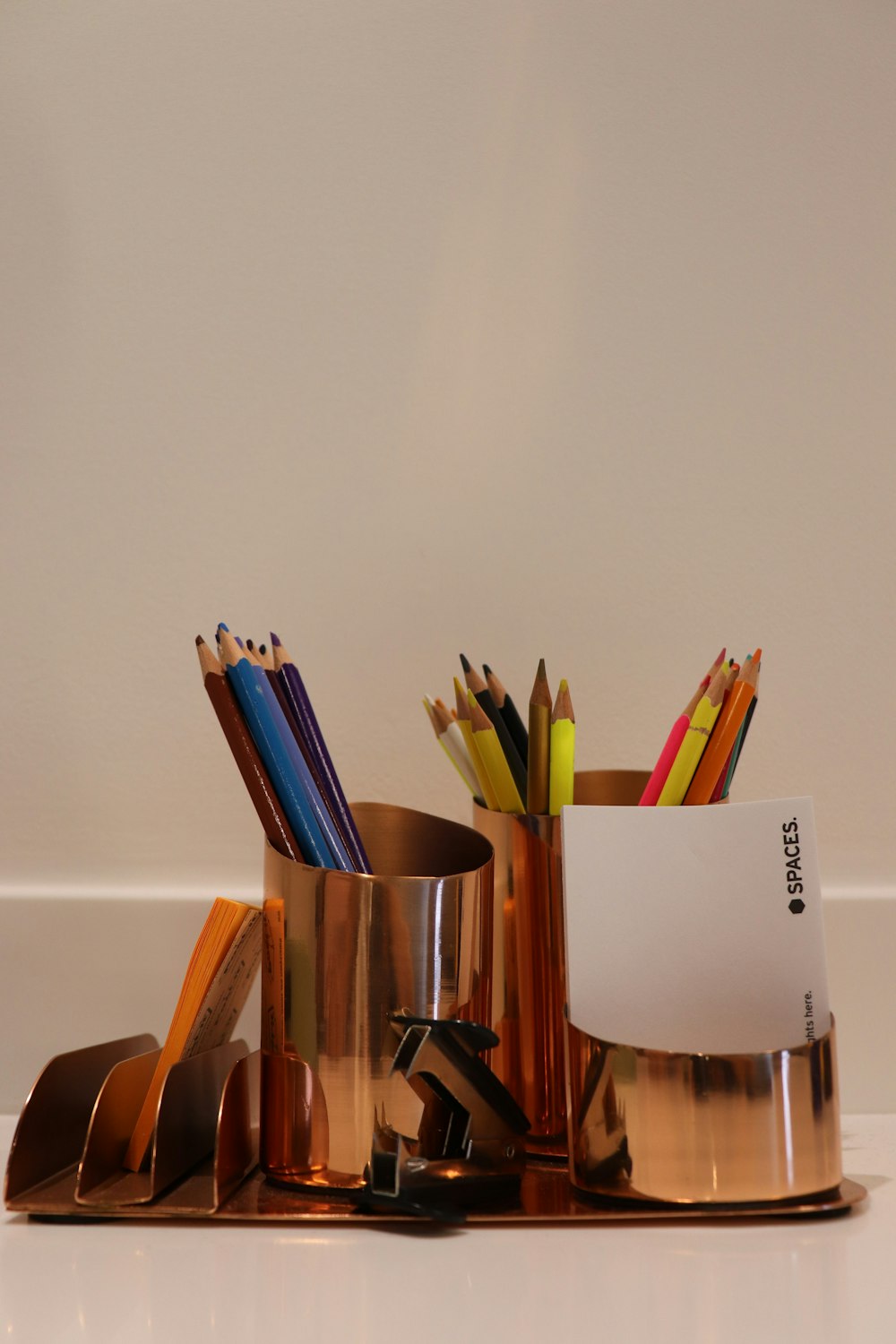 a group of pencils in a glass jar