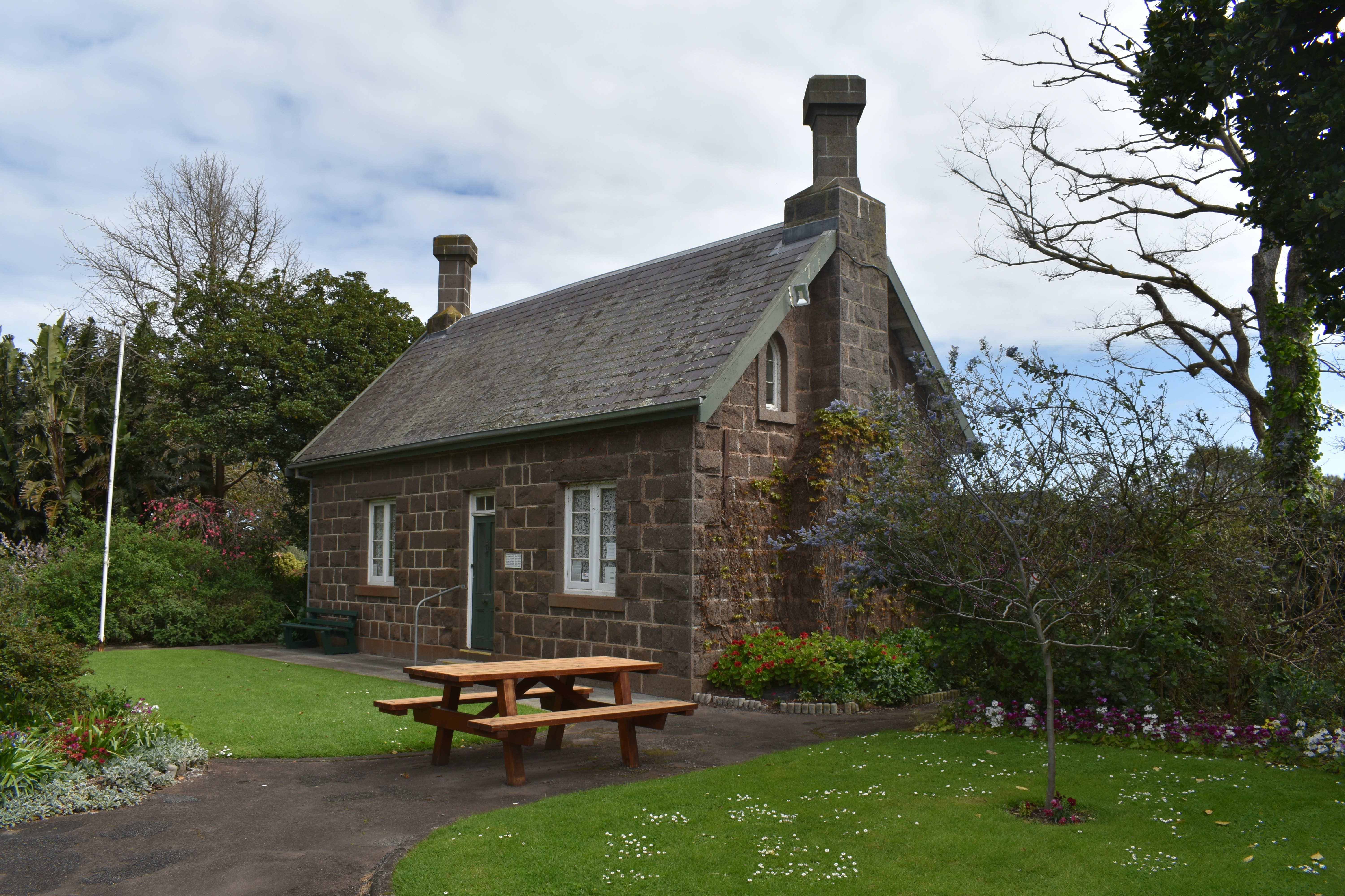 a brick house with a picnic table