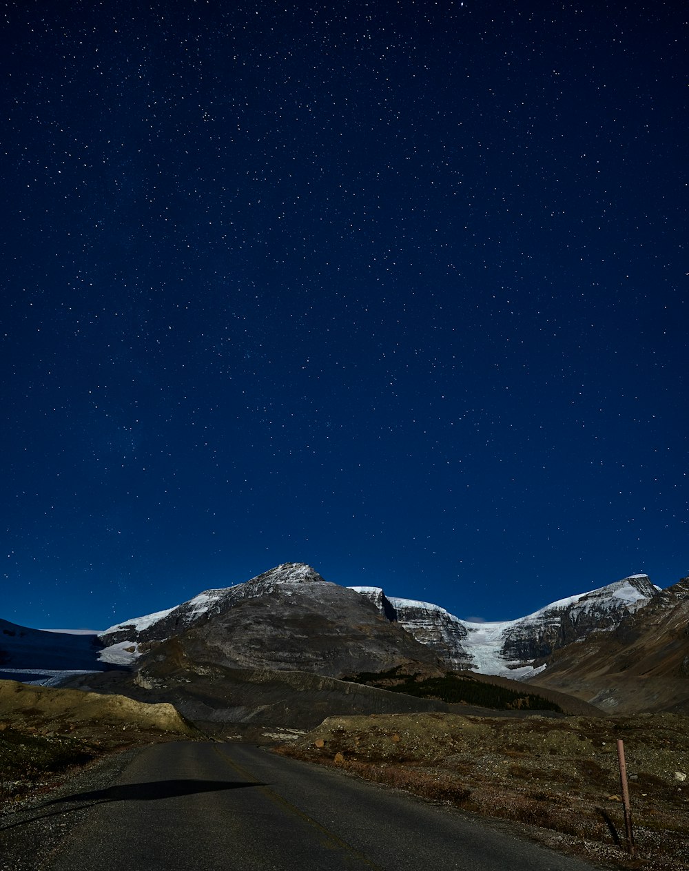 a road leading to a snowy mountain