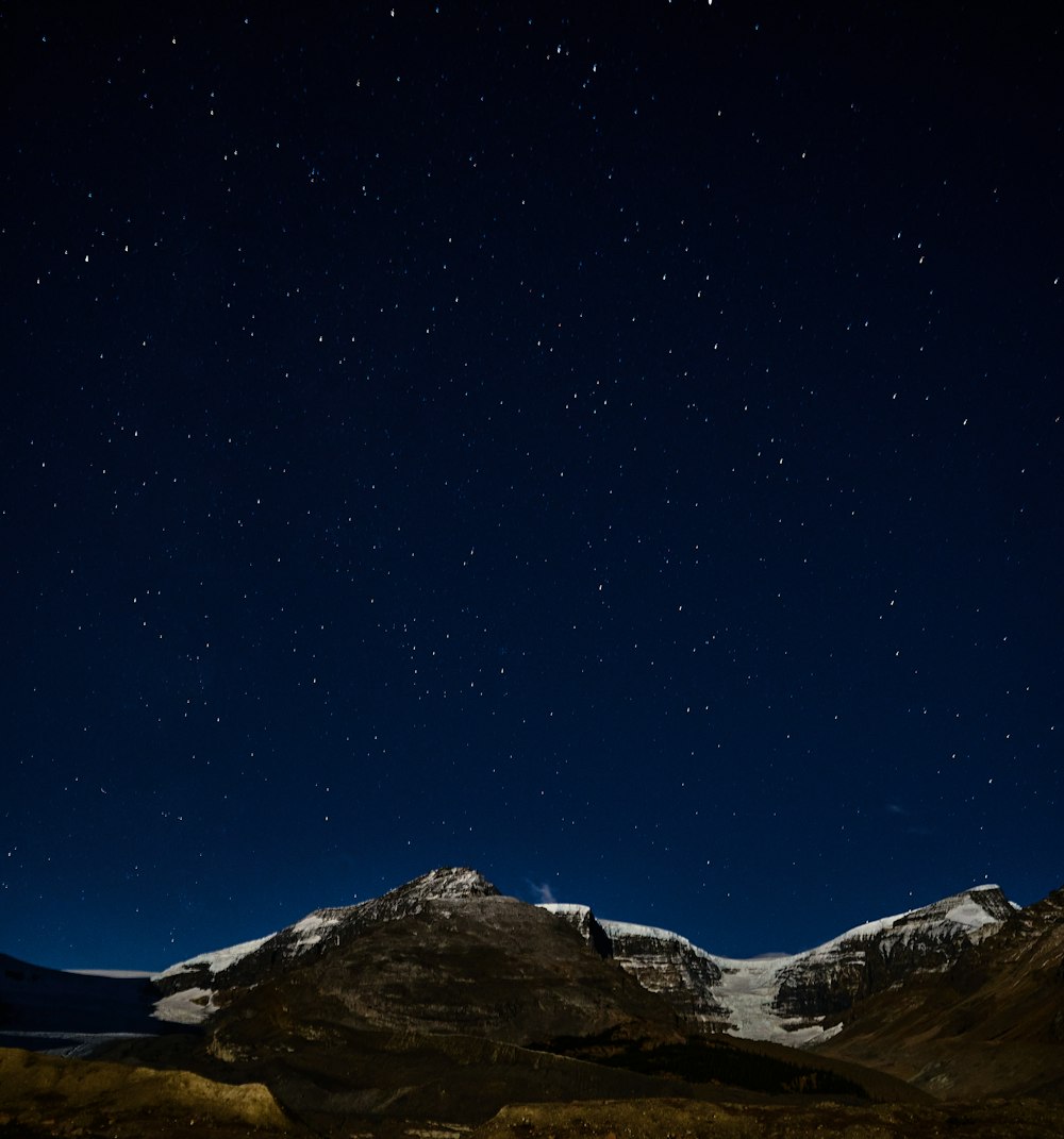 Una montaña nevada y estrellas en el cielo