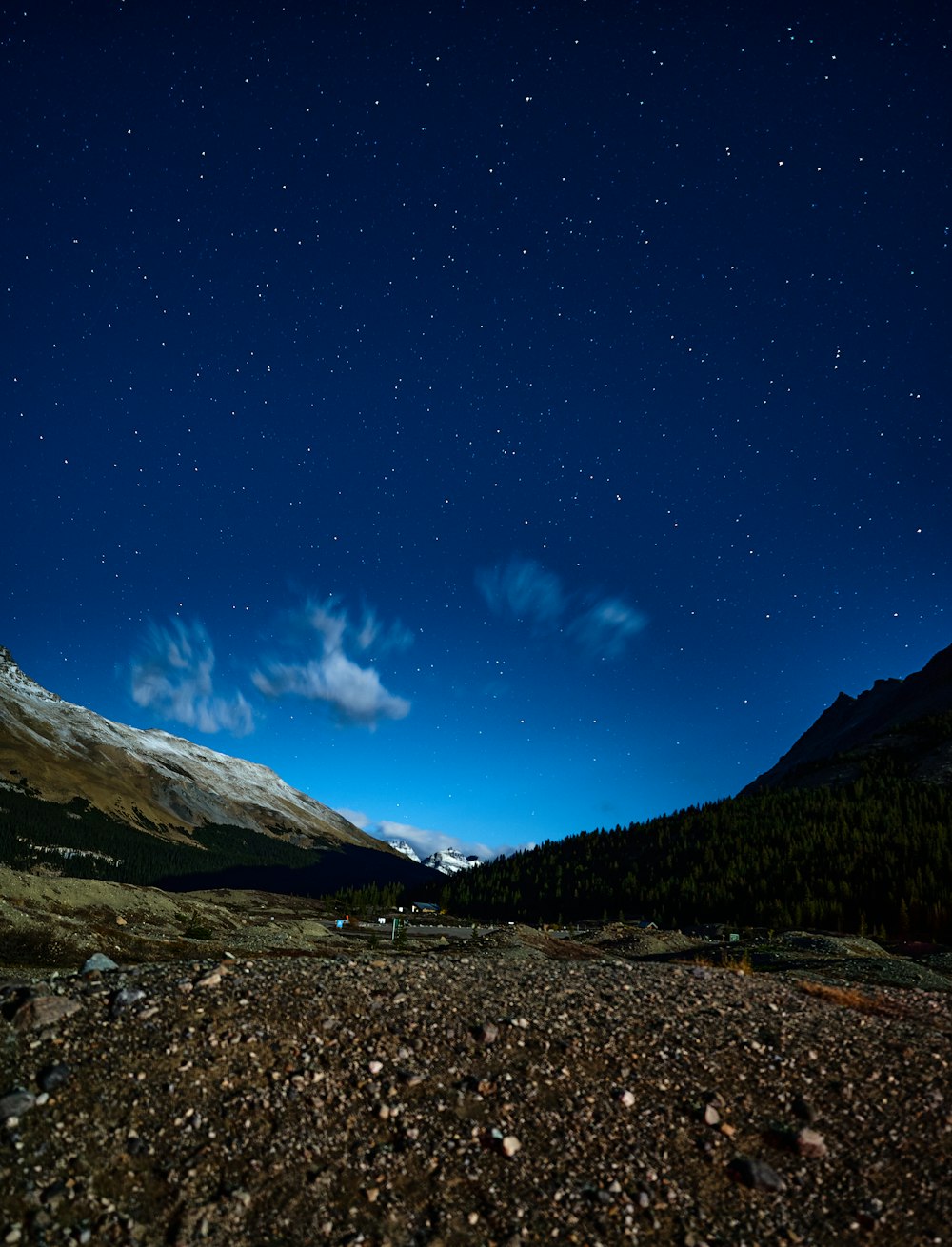 a rocky road with mountains in the background