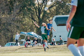 An intense moment as two rivals contest a header in a high-stakes European fixture.