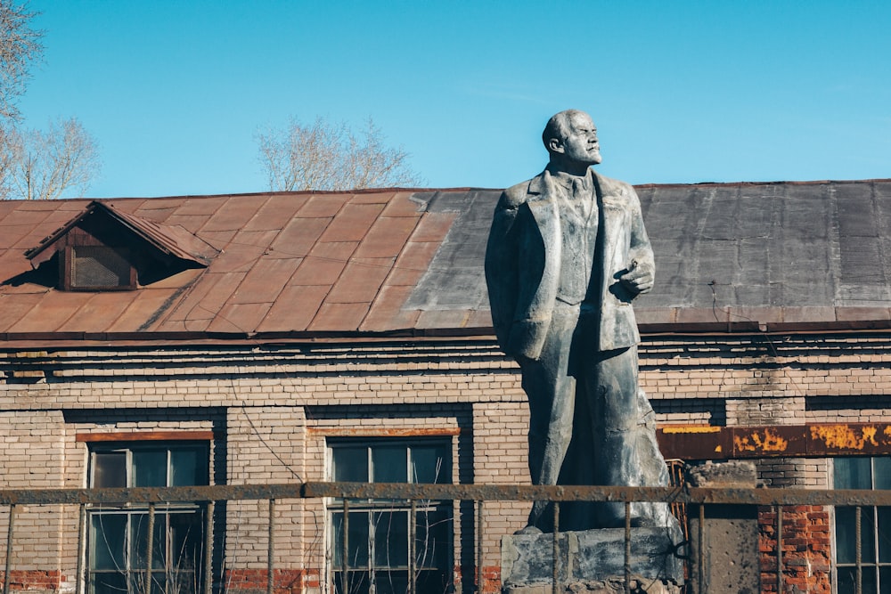 a statue of a person in front of a building