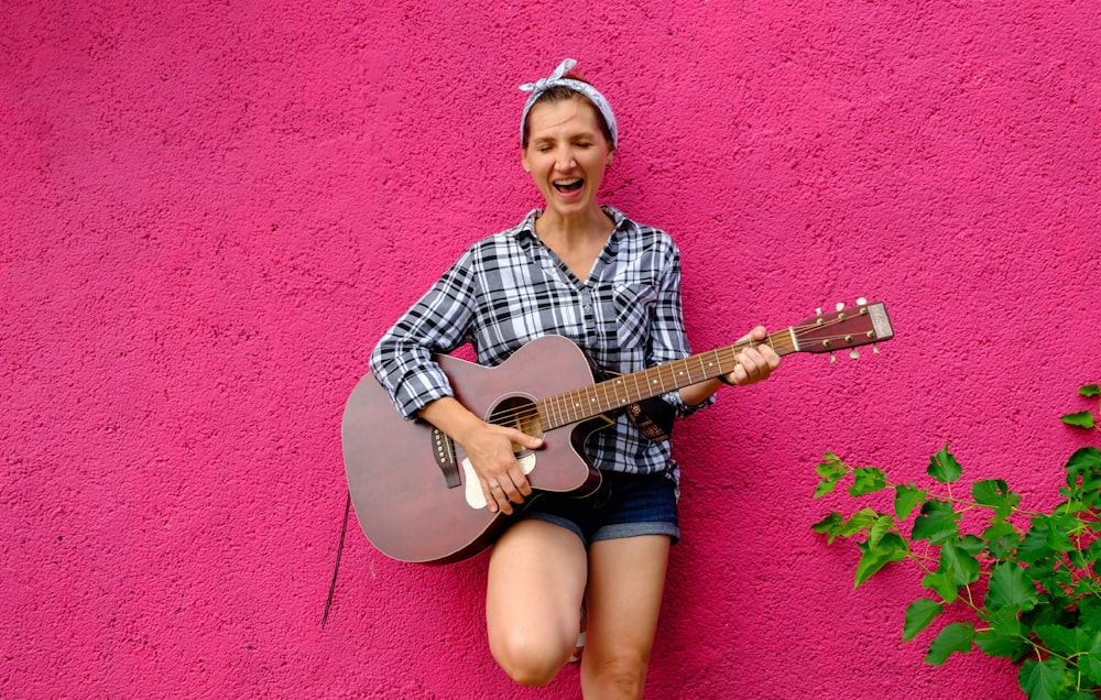 a woman playing a guitar