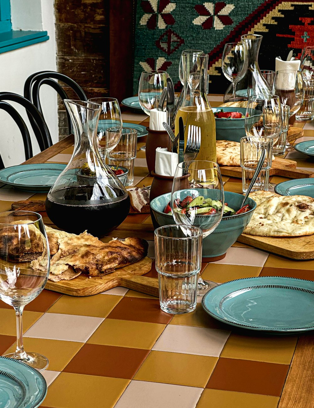 a table with many dishes and glasses on it