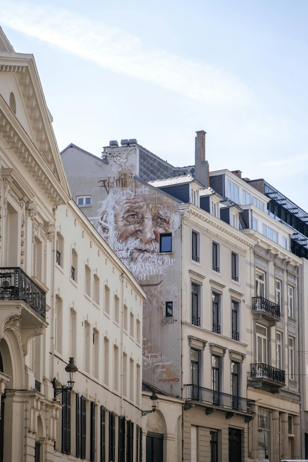 a group of buildings with a mural on the side