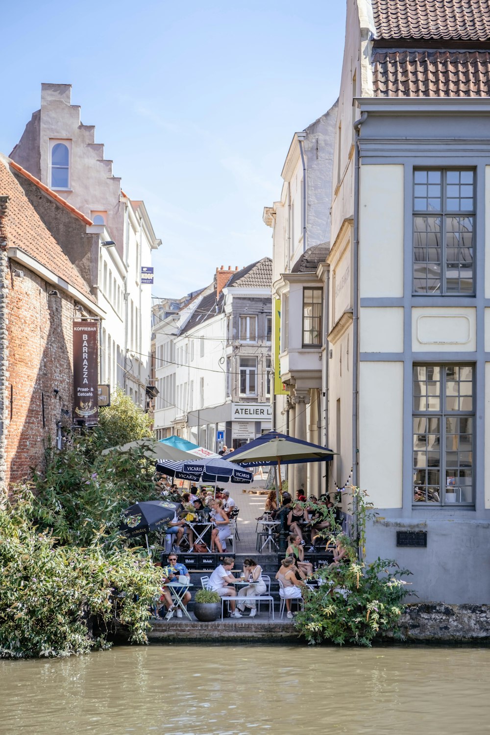 a group of people sitting on a bench by a river