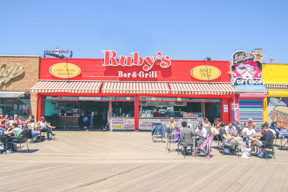 a group of people sitting outside a restaurant