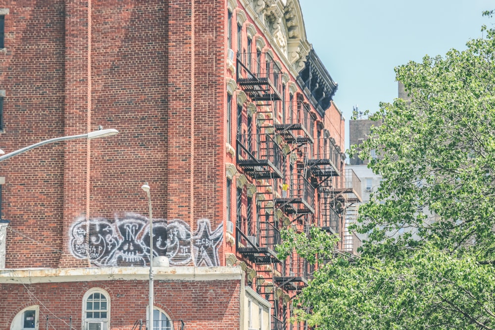 a brick building with graffiti on it