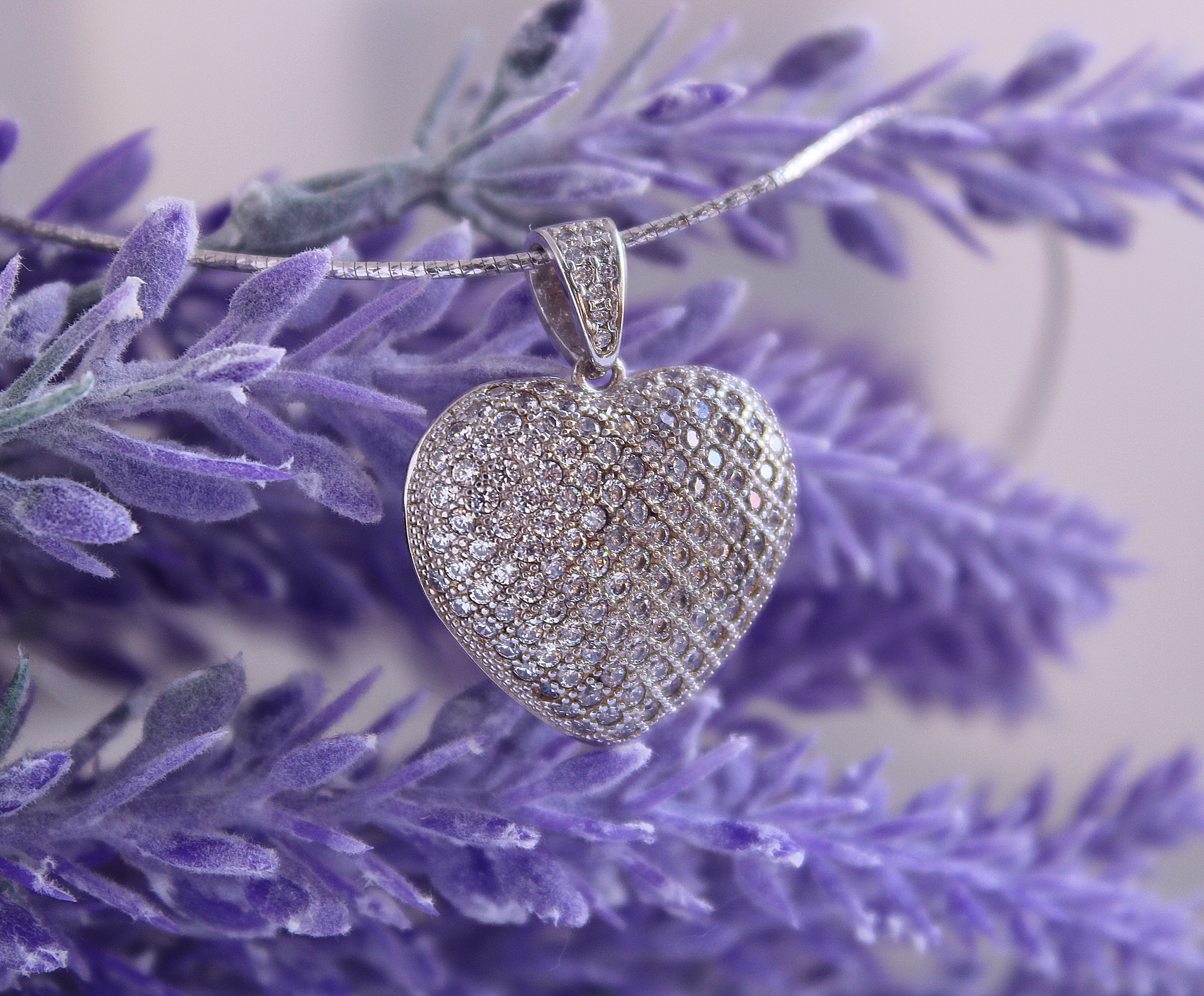 a silver ball on a purple chain