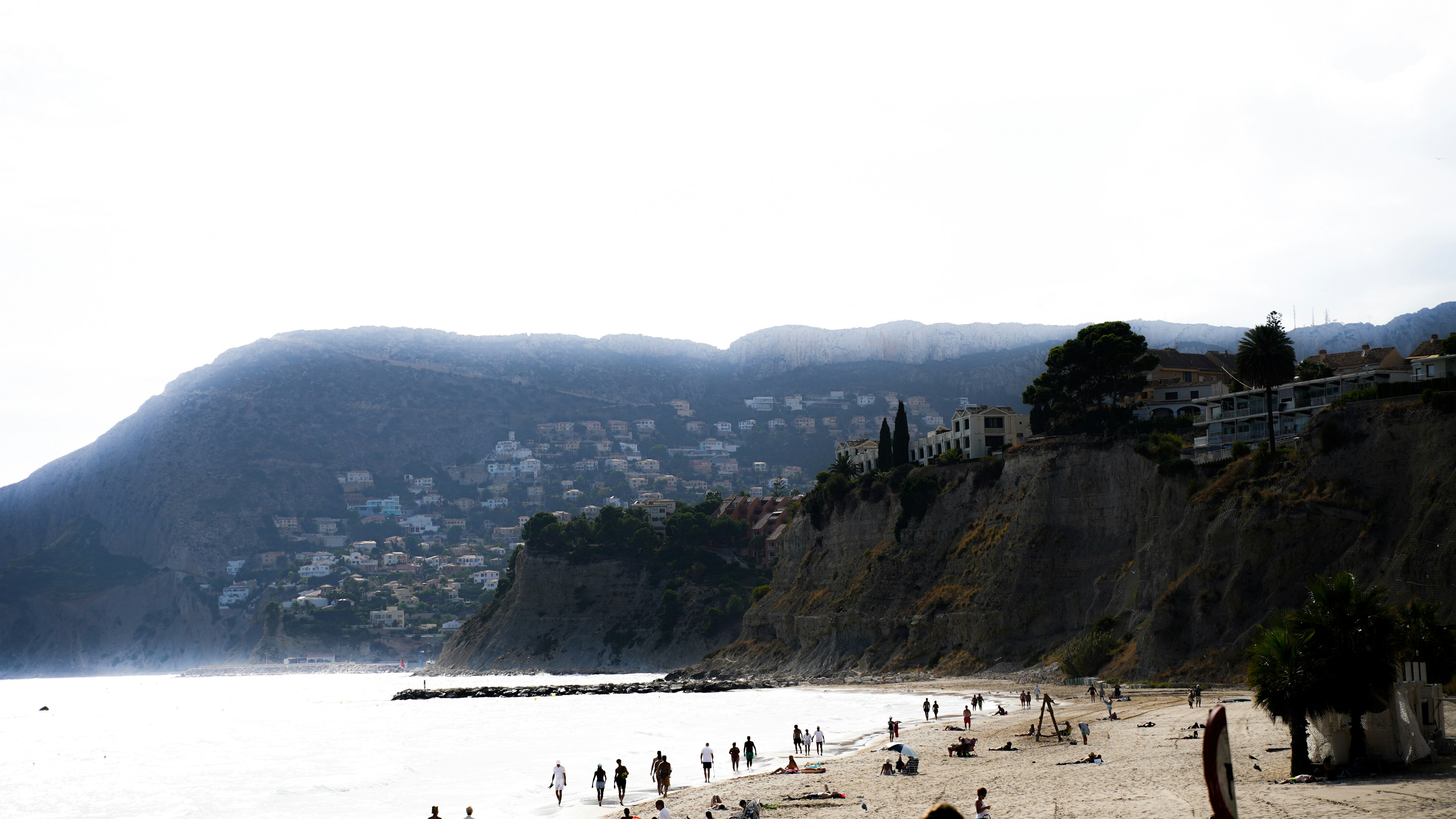Beach · a beach with people and buildings on it by a body of water
