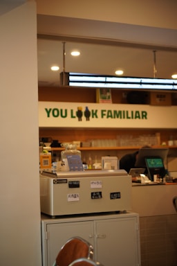 Cozy interior of Yilin's Cafe with a welcoming counter and warm lighting.