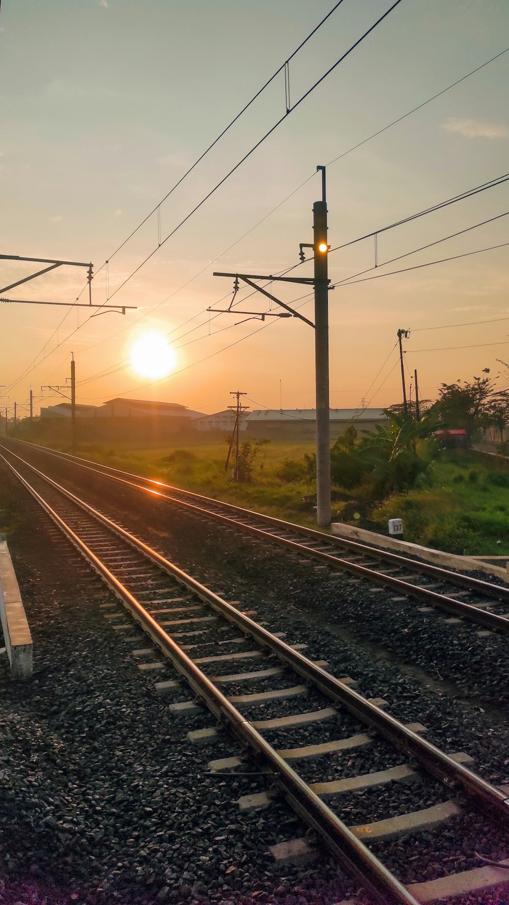 train tracks with a sunset in the background