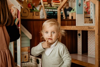 a girl with her finger in her mouth