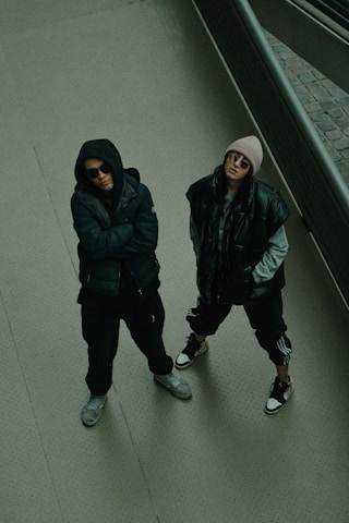 two people standing on a sidewalk