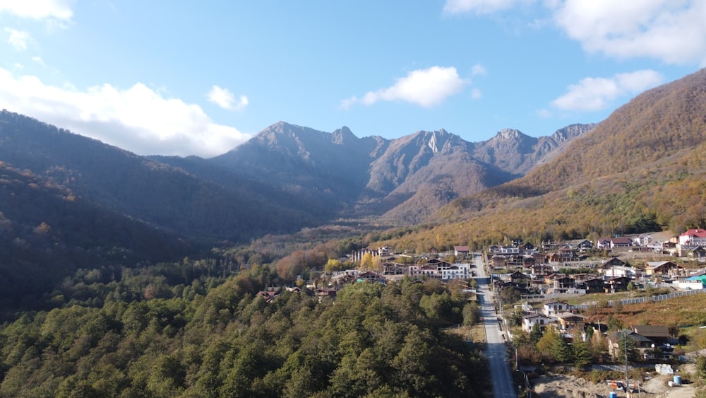 a road going through a valley with mountains in the background