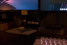 Man studying late at night with futuristic holographic screens displaying data and goals around him.