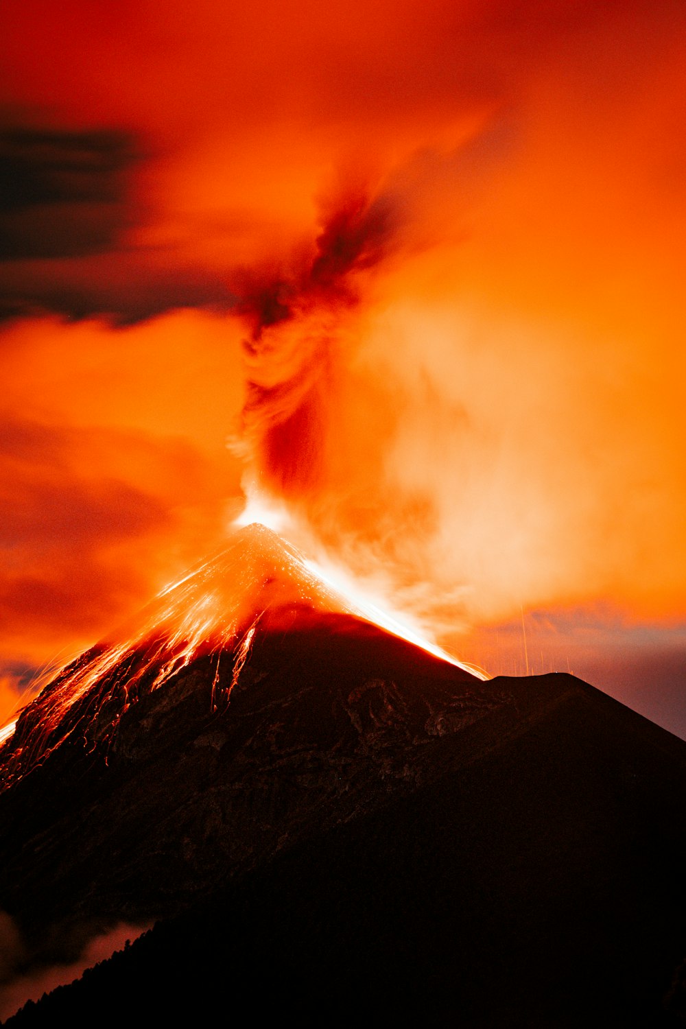 a volcano erupting at night