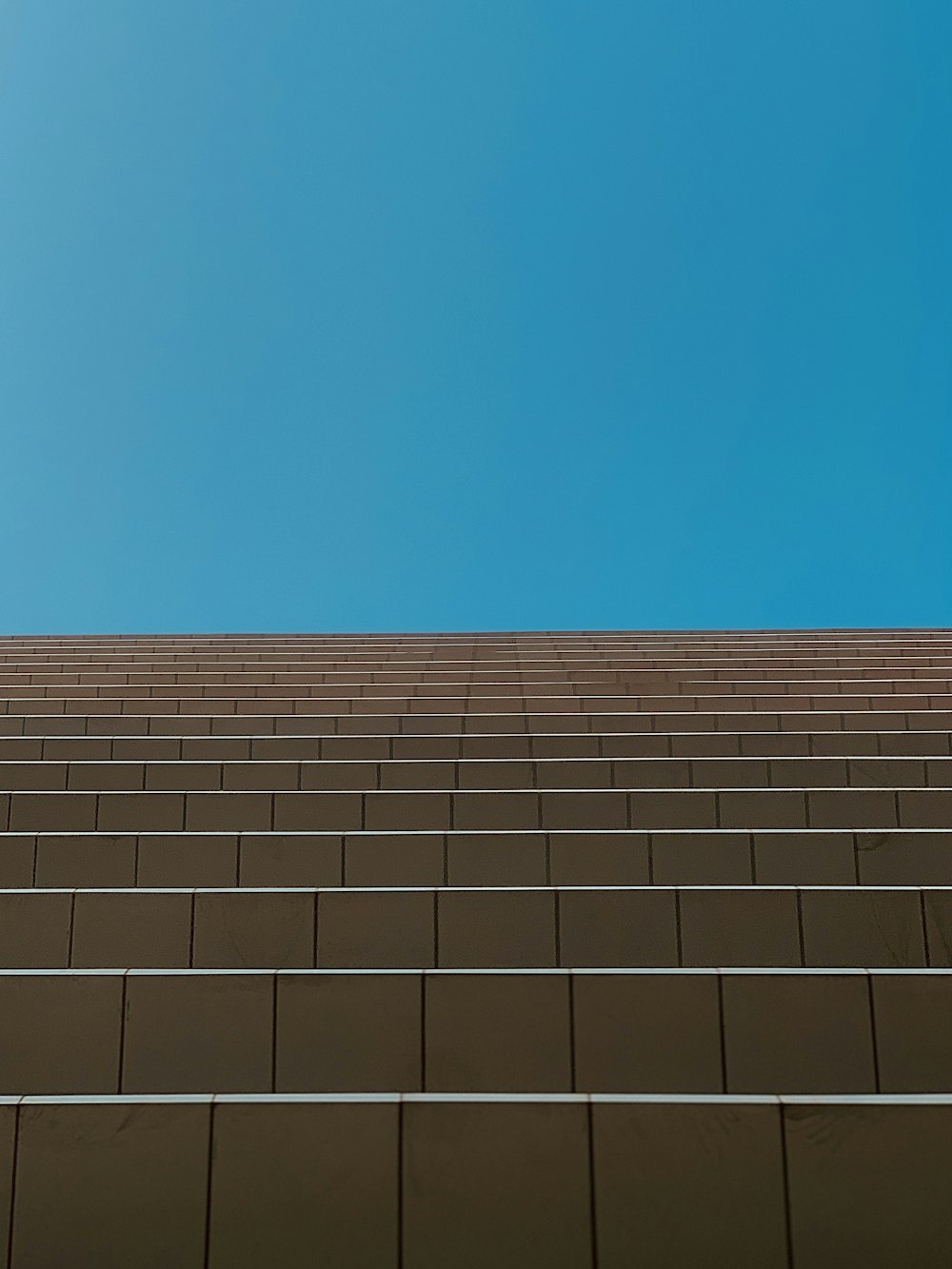 a brick wall with a blue sky