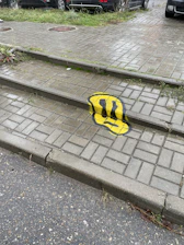 a yellow and black painted stone