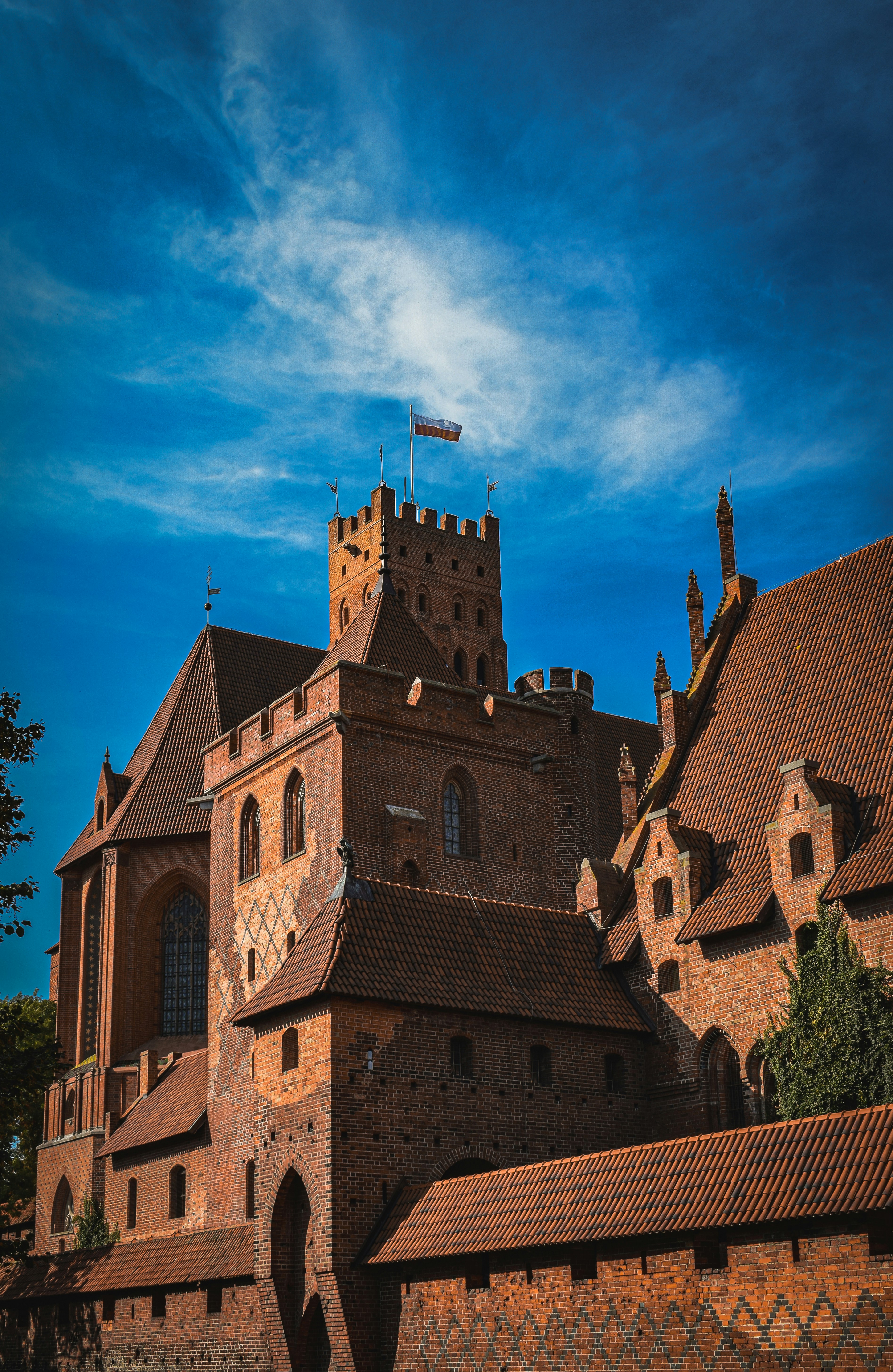 a large brick building with a flag on top