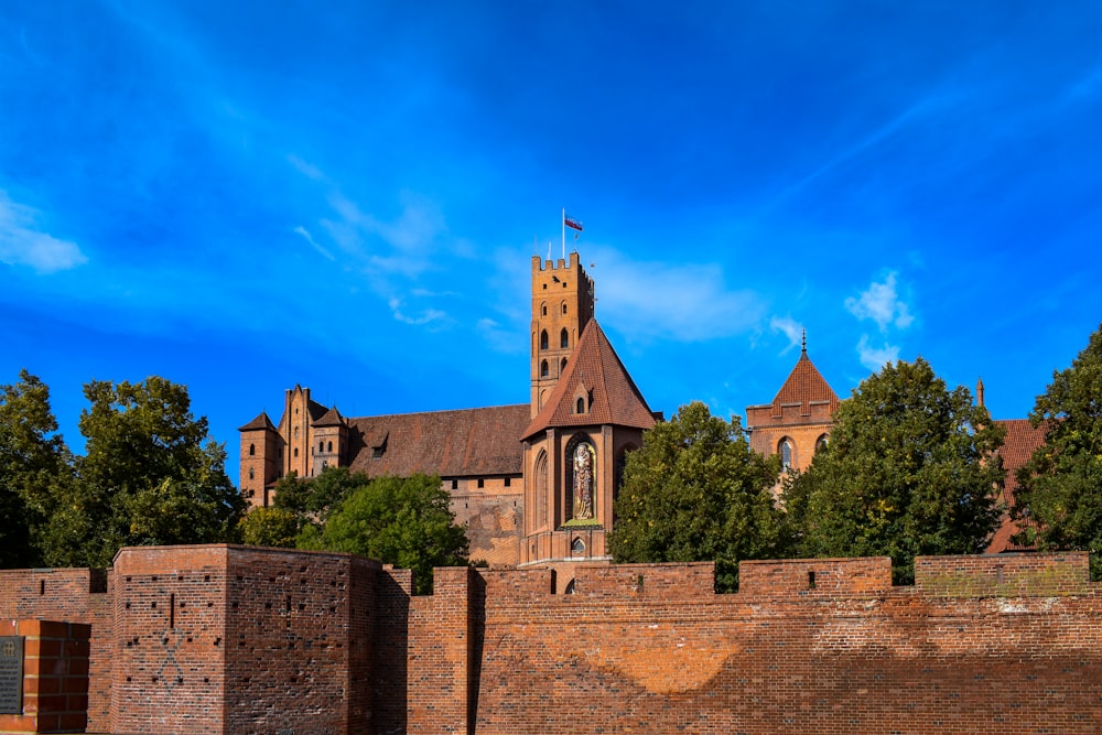 a brick wall with a brick wall and a brick wall with a building in the background