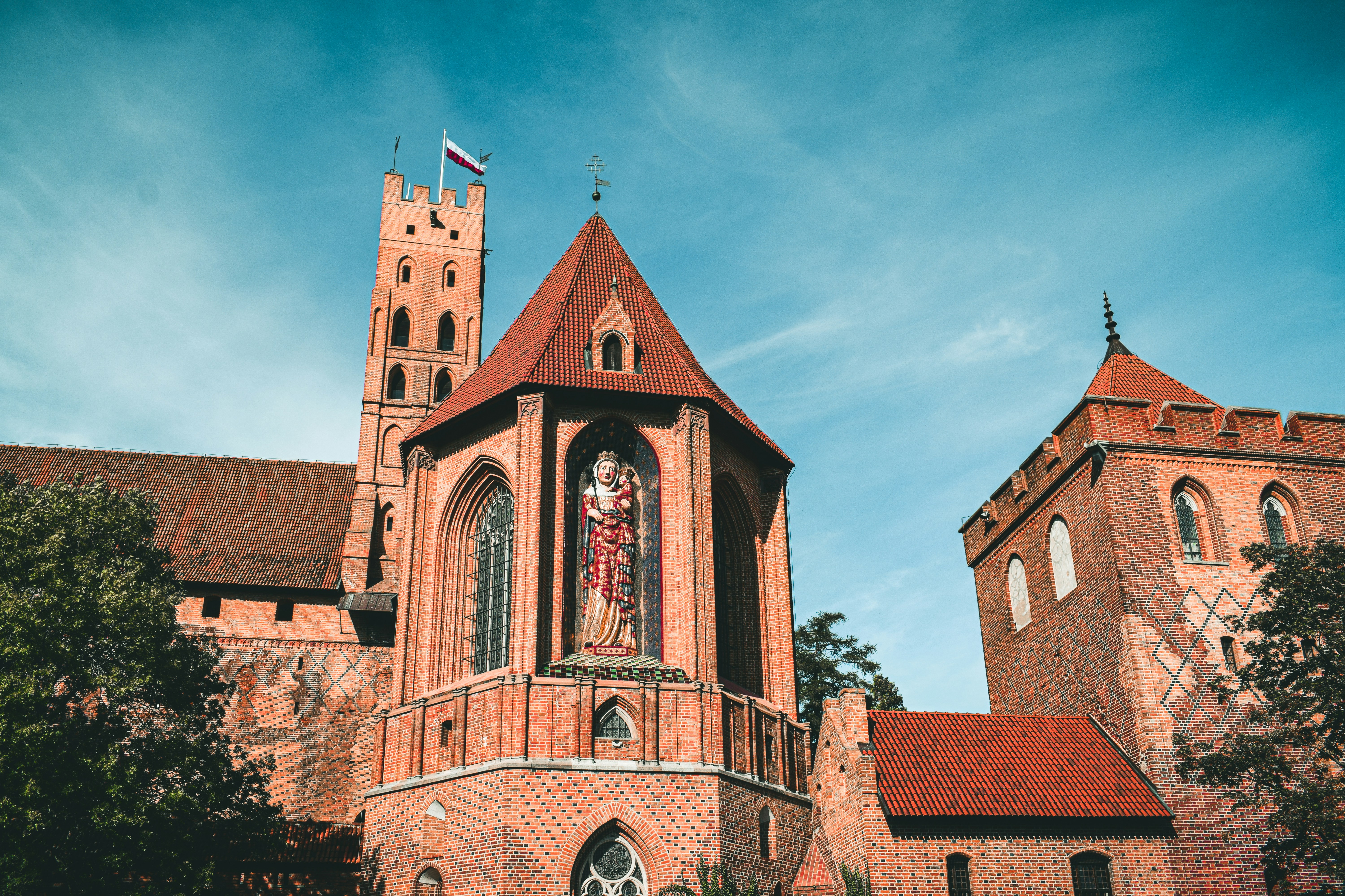 a large brick building with a flag on top