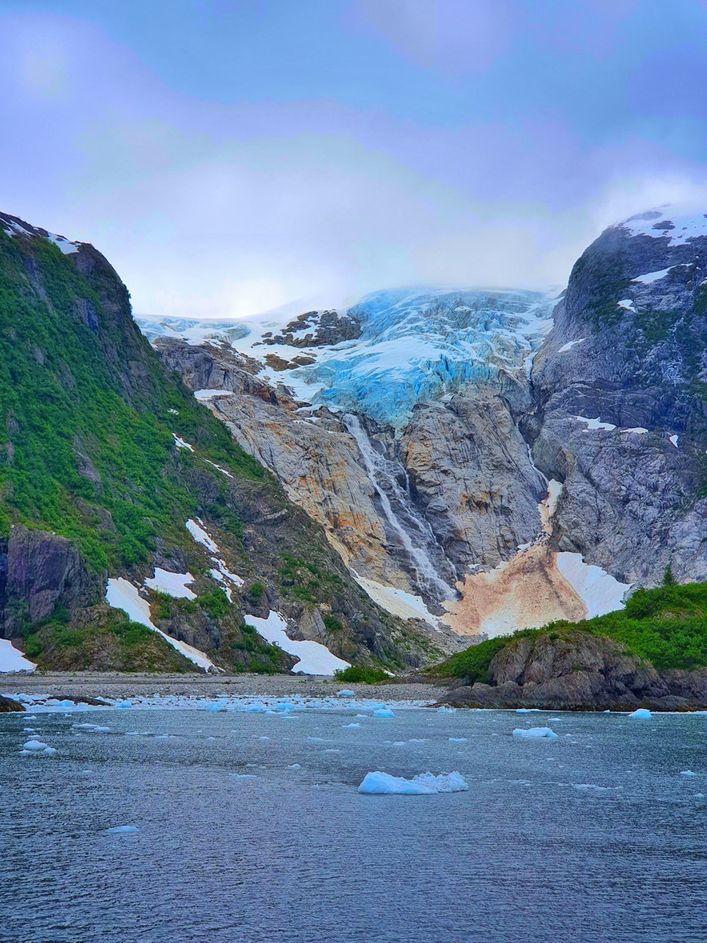 a body of water with mountains around it