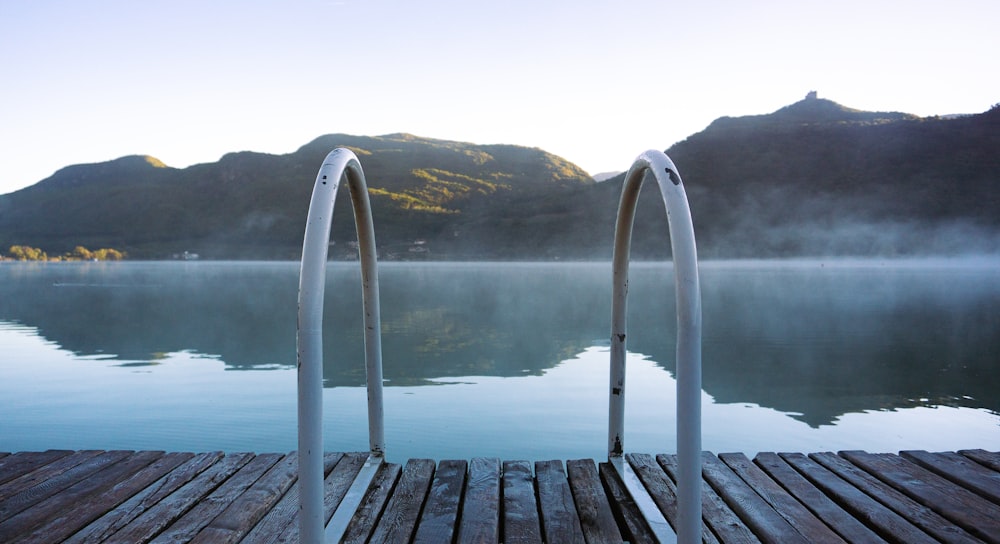 a group of metal poles on a dock over water