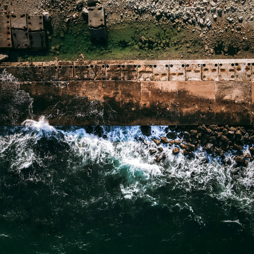 a waterfall with a stone wall