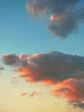 Colorful musical notes floating over a peaceful sunset background.