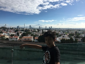 A smiling family standing outside their new home, holding keys with a backdrop of a modern city skyline.