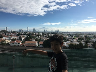 A happy child playing safely behind a well-secured balcony safety net in a Bengaluru home.