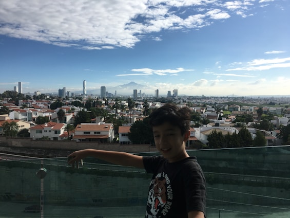 A smiling family standing outside their new home, holding keys with a backdrop of a modern city skyline.