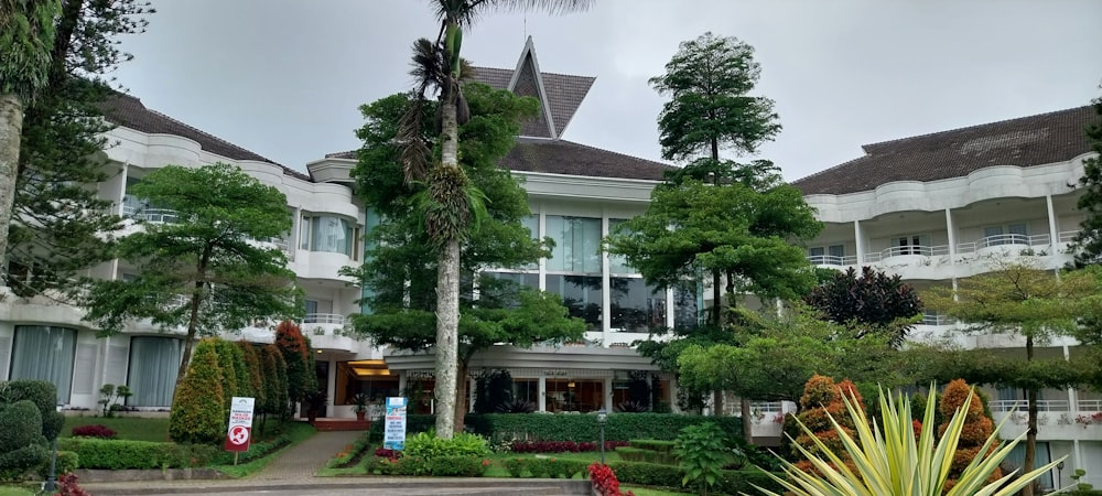 a building with trees and bushes in front of it