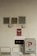 A beige tiled wall contains various fire safety and parking signs. Two sprinkler fire alarm circular signs are mounted on the wall above red signs indicating a fire department connection. There is a prominent 'NO PARKING' sign to the right side, and two wall vents and a central air vent are also visible.