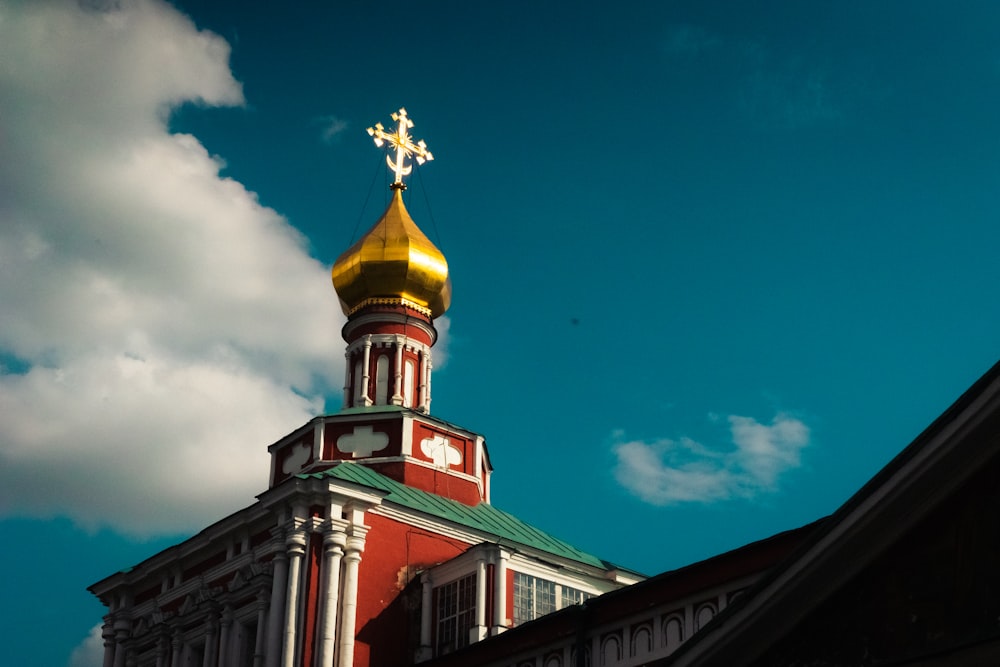 a building with a gold statue on top