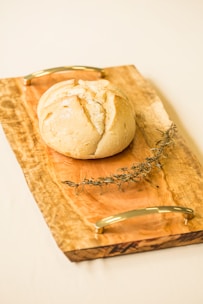 A sourdough loaf cooling on a wooden board, representing personal interests.