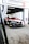 A racing car with a black, red, and white color scheme is positioned in a motorsport garage under a sign that reads 'Century Motorsport BMW M4 GT3'. The car has various brand stickers, including Sonax and Pirelli, and is partially outside the garage ready for a race.
