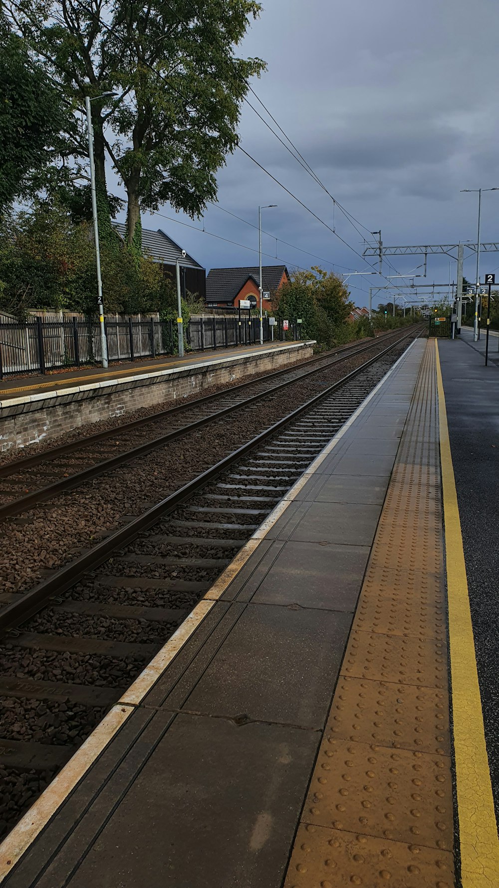 train tracks next to a road